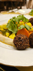 Falafel balls with hummus, close-up. Middle Eastern Arabic food, fried falafel, hummus and vegetables. Delicious and healthy food