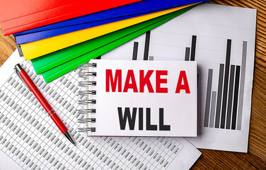 MAKE A WILL text on a notebook with pen, folder on a chart background