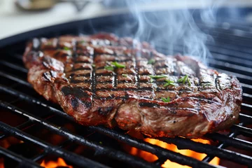 Poster Tasty steak on barbecue grill © Firn