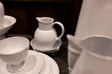 A wide variety of white plates bowls and mugs lined up