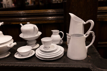 A wide variety of white plates bowls and mugs lined up