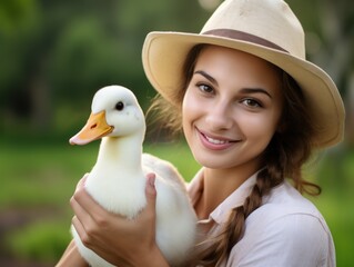 Cheerful farmer holding duck in his arms