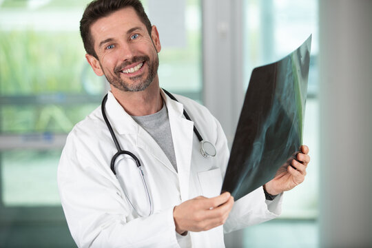portrait of male doctor holding xray