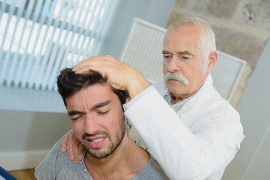 young man suffering from neck pain