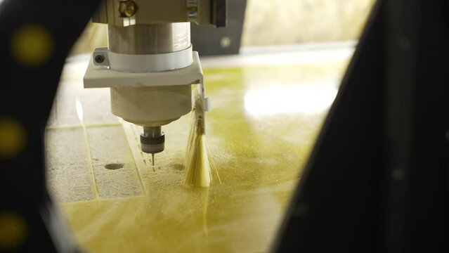 The CNC drills a hole in the plastic. plastic carving. Head close-up