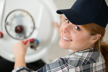 a female technician repairing boiler