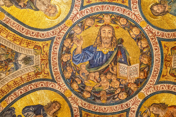 Fototapeta na wymiar Close-up on colorful religious mosaic decorating interior of historic Basilica in Rome showing a smiley Jesus waving his hand