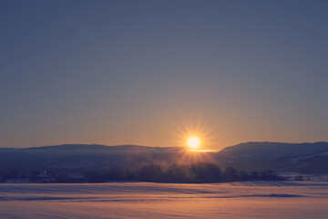 Fototapeta na wymiar Sunrise above the Totenaasen Hills in winter.