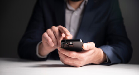 Close-up photo of male hands with smartphone