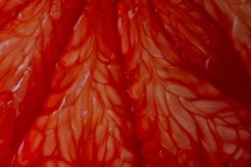 Zelfklevend Fotobehang Close up of sliced ripe grapefruit, macro. Red fresh grapefruit surface background or texture © OlegD