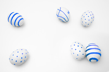 White chicken egg with blue stripe pattern, polka dots, line. Copyspace for text. Top view. Egg hunt. Religious holiday of Happy Easter on table. Minimalistic greeting card for family. Gift for kids