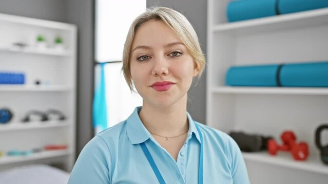 Blonde woman in a clinic room with eyes closed and open, showcasing a healthcare environment.