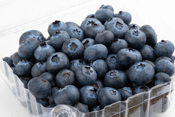 Ripe blueberries in a plastic box. Selective focus.
