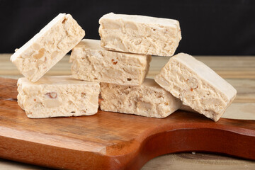 Square of delicious nougats on cutting board.