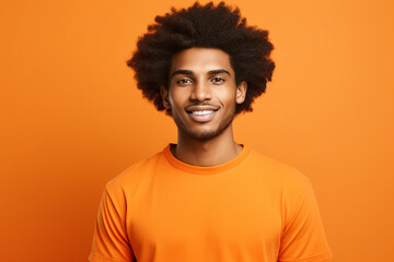 Fototapeta na wymiar Young man with afro hair wearing orange t-shirt smiling on orange background. Generative AI.