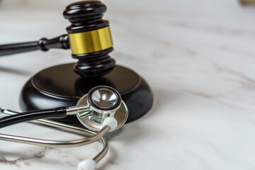 judge's gavel and a professional stethoscope representing legal decisions in health care. The intersection of law and medicine