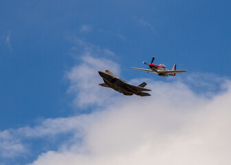 F35 and prop plane in blue sky