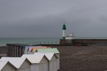 lighthouse and beach cabins on the beach