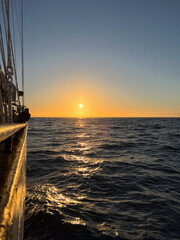 Sunset over the Atlantic Ocean seen from a tall ship
