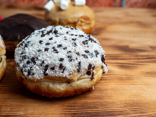 Sweet donut on a wooden background. Sweet bun close-up.