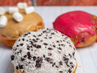 Sweet donut on a wooden background. Sweet bun close-up.