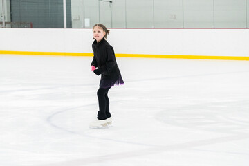 Figure skating practice at an indoor skating rink