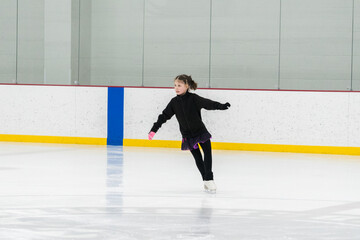 Figure skating practice at an indoor skating rink