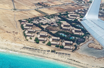 Aerial view from airplane of an tourist resort at the beach