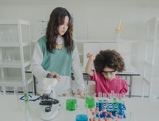 Portrait child kid girl asian young student tree people team group learning and smile have fun happy with science lab technology with in the classroom has a tubetest Microscope chemicals on table