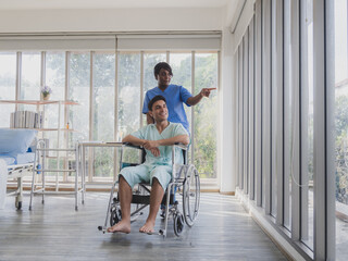 Portrait patient caucasian man sit wheelchair with woman nurse carer physical therapist African-American two people talk helping support give advice feel relax smile happy in hospital room service.