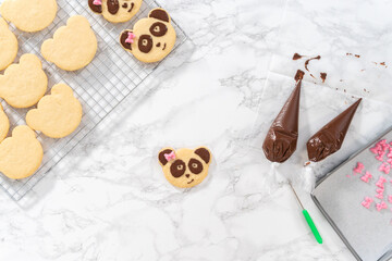 Fototapeta na wymiar Panda shaped shortbread cookies with chocolate icing