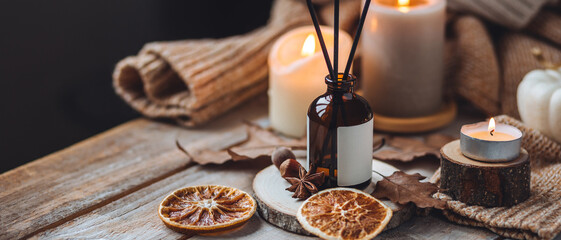 Hello autumn, cozy slow living. Pumpkin, aromatic candle, warm sweaters, dry fall leaves, cinnamon,...