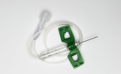Closeup of one isolated butterfly safety winged IV needle with tube on white background