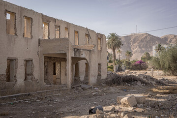 The destroyed abandoned building and the Mount of Temptation on the background at Palestinian city of Jericho at West Bank, Palestine.  - obrazy, fototapety, plakaty