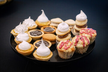 white plate full of thin dough. catering for events. Sweets served at a party. Cream, chocolate, dulce de leche, meringue