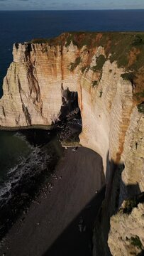Aerial 4k drone view of Etretat. L'Aiguille, The Needle, Famous Alabaster chalk seacoast, Porte Aval cliffs, Natural Rock Arch Of &Eacute;tretat, Normandy, France, Atlantic Ocean, French holidays, landscape