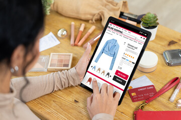 Woman shopping online on internet marketplace browsing for sale items for modern lifestyle and use...