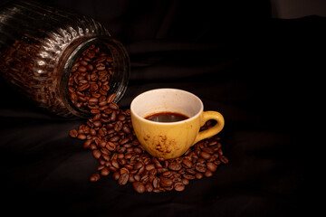 closeup photo of cup of espresso and coffee beans