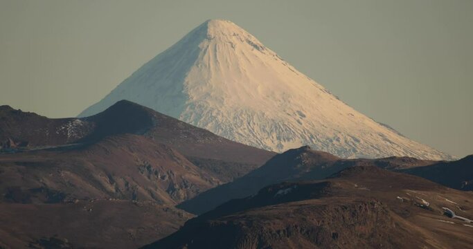 Alpine landscape in summer. View of volcano Lanin peak covered with snow and the Andes mountains in Patagonia Argentina.