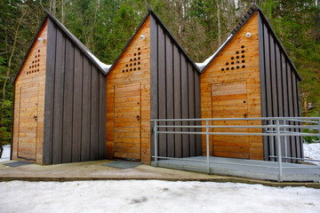 wooden public toilets in the forest along the tourist trail route