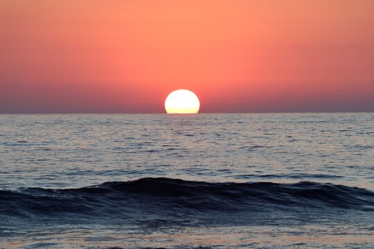 sunset at the ocean, the sun sinks into the sea