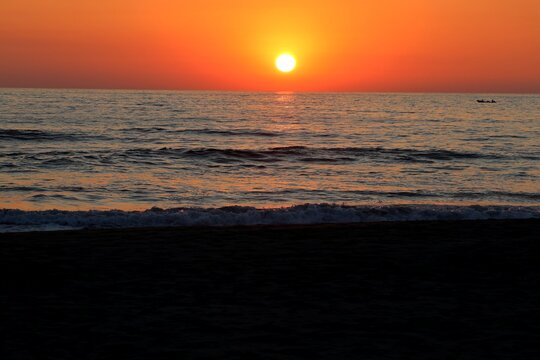 sunset at the ocean, the sun sinks into the sea