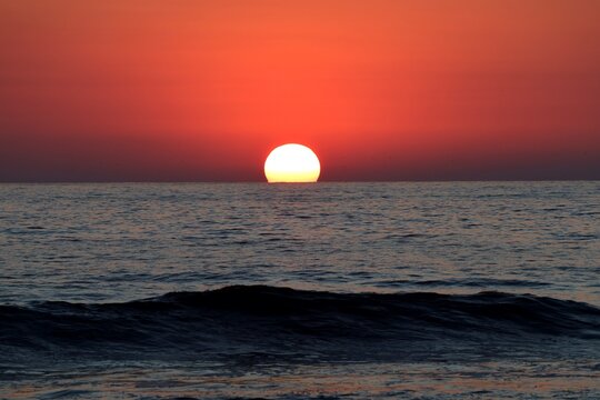 sunset at the ocean, the sun sinks into the sea