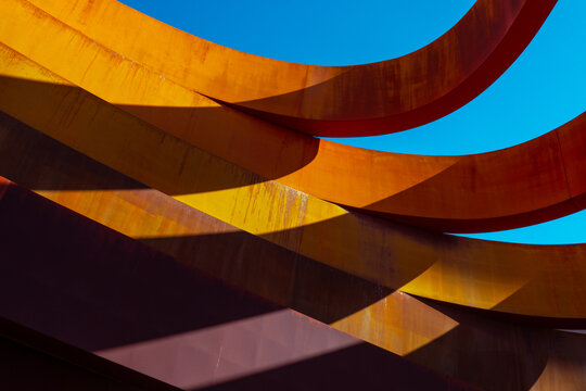 Abstract view of a modern sculptural architecture with vibrant red and yellow curves.