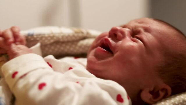 A baby crying because of a tummy ache, a problem with colic in a newborn