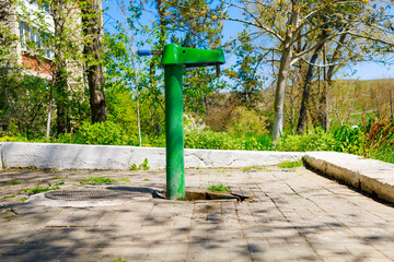 Outdoor pump with drinking water. Background with selective focus and copy space