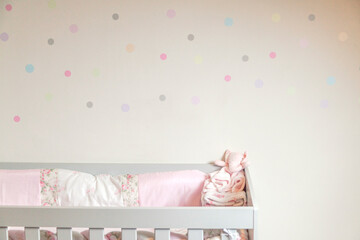 Baby crib with colorful polka dot wall. Crib concept. Children's concept.