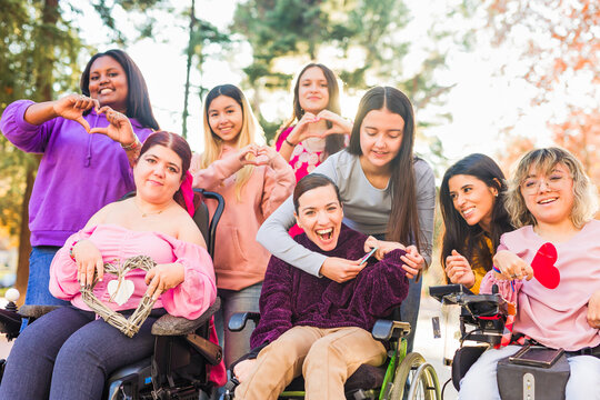 International womens day Inspire Inclusion multiethnic group do love heart with hands. Wheelchair
