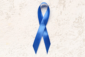 Blue awareness ribbon on light background. Prostate cancer concept