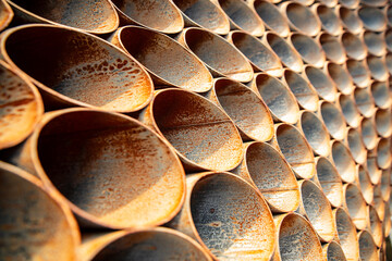 Rusty iron, Symmetrical metal pipes under the sun, with light shadow